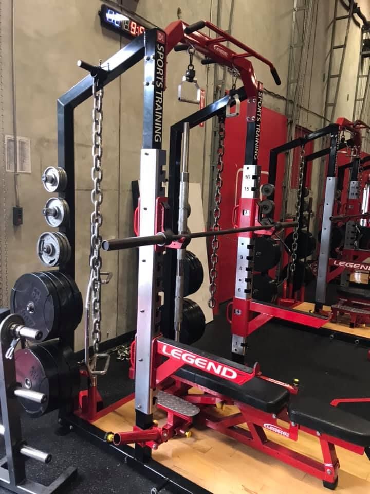 A gym with a lot of exercise equipment and a bench. 28.4845° N, 81.2519° W