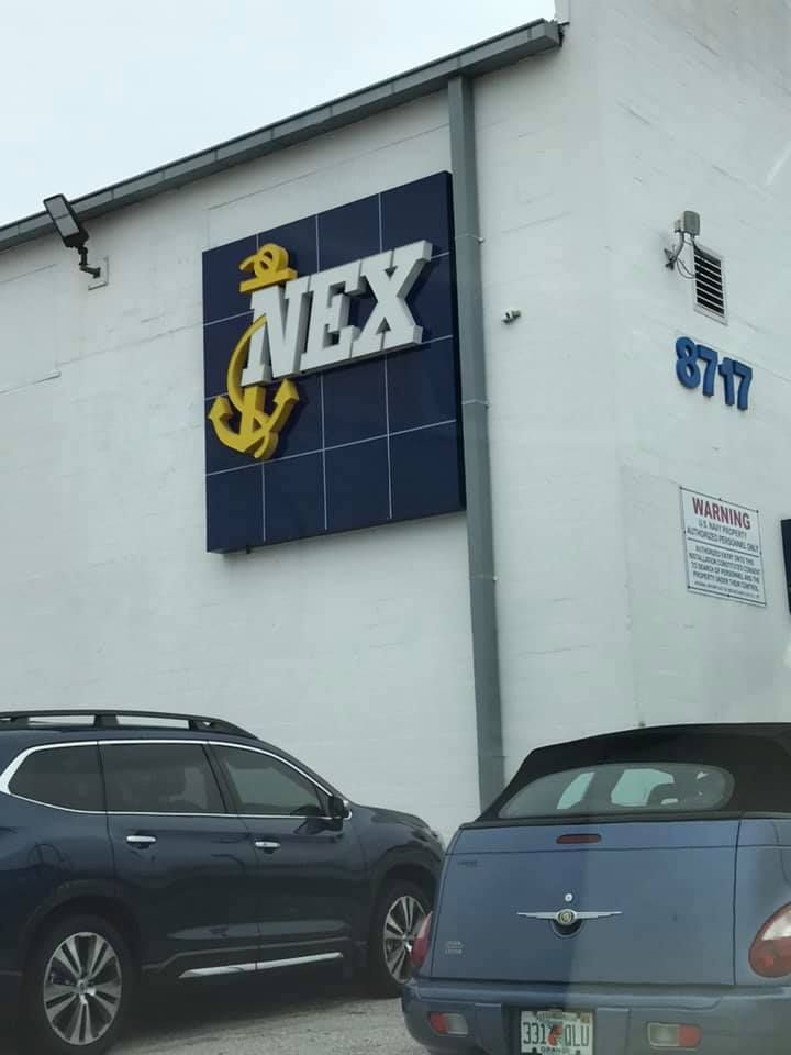 Two cars are parked in front of a NEX store 28.4845° N, 81.2519° W