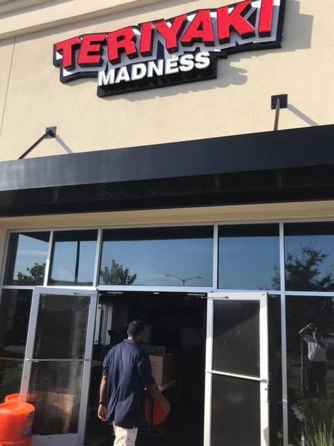 A man walking into a teriyaki madness restaurant 28.4845° N, 81.2519° W