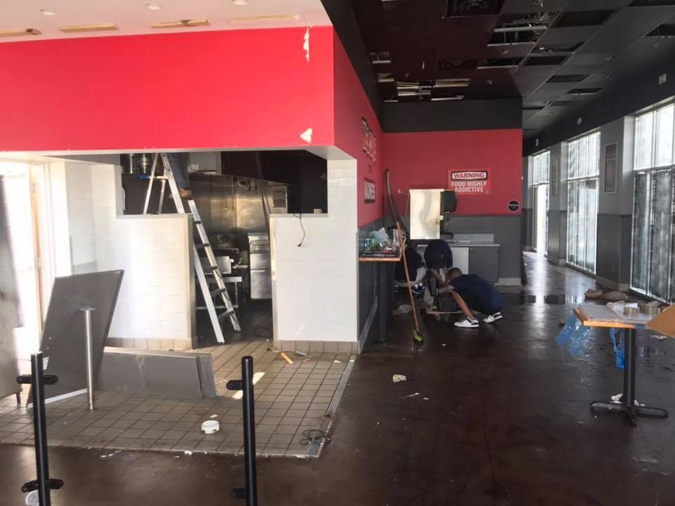 A man is cleaning the floor of an empty restaurant 28.4845° N, 81.2519° W