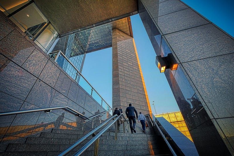 A group of people are walking up a set of stairs.