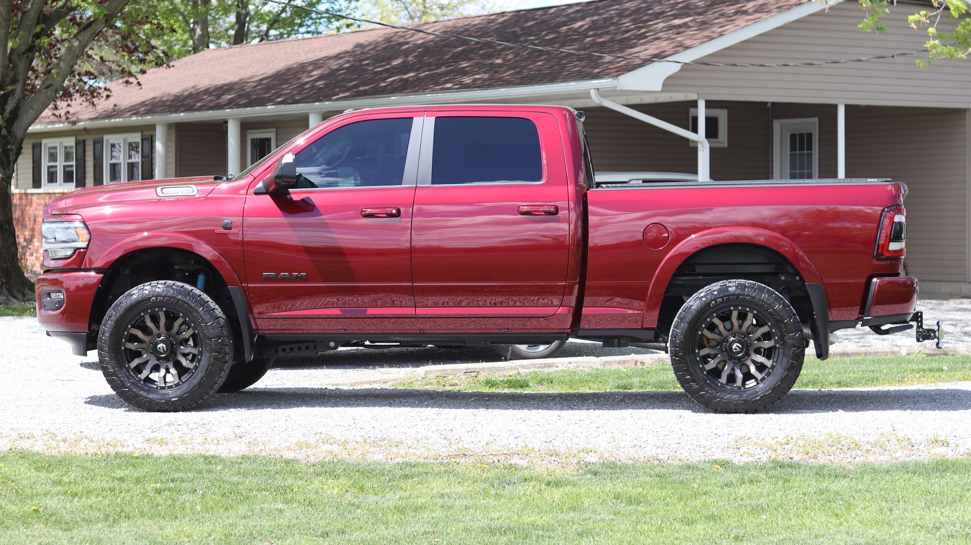 A red truck is parked in front of a house.