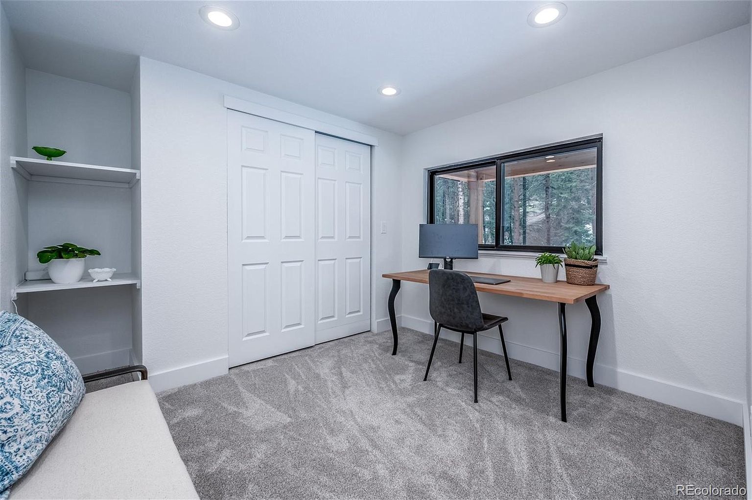 A room with a desk and chair in it