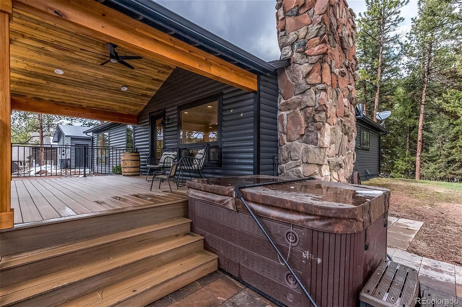 There is a hot tub on the deck of a house.