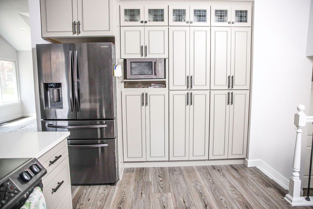 A kitchen with white cabinets and stainless steel appliances.