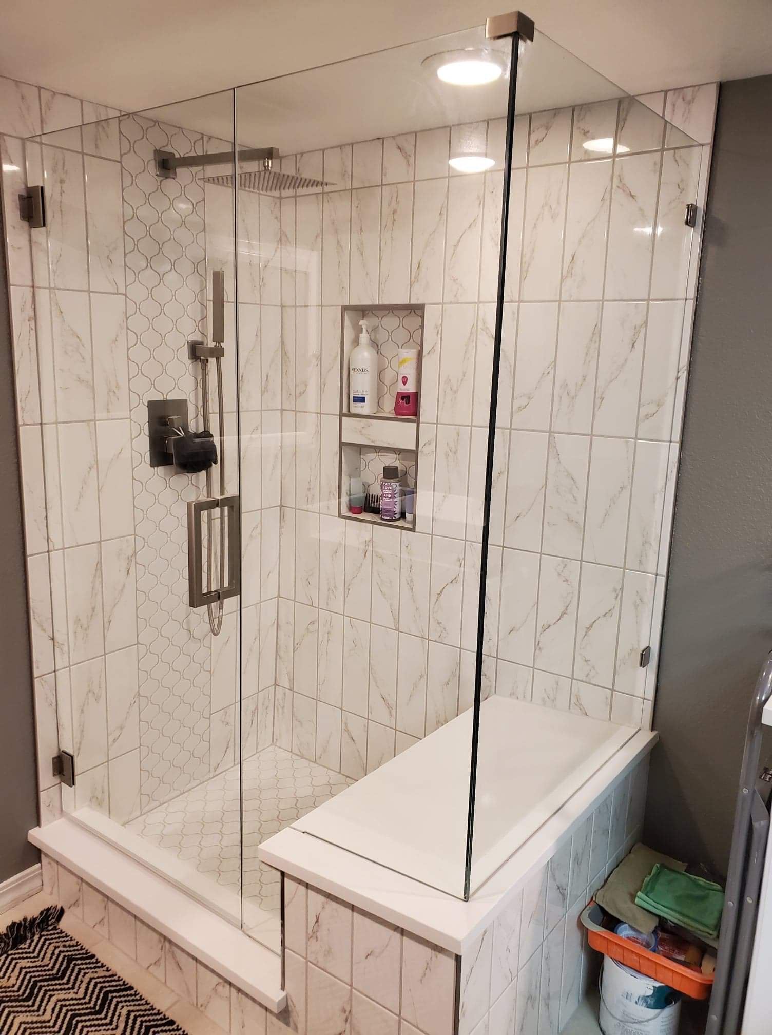 A bathroom with a walk in shower and a bathtub.