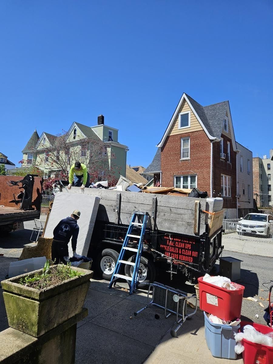 A construction site with a brick house in the background