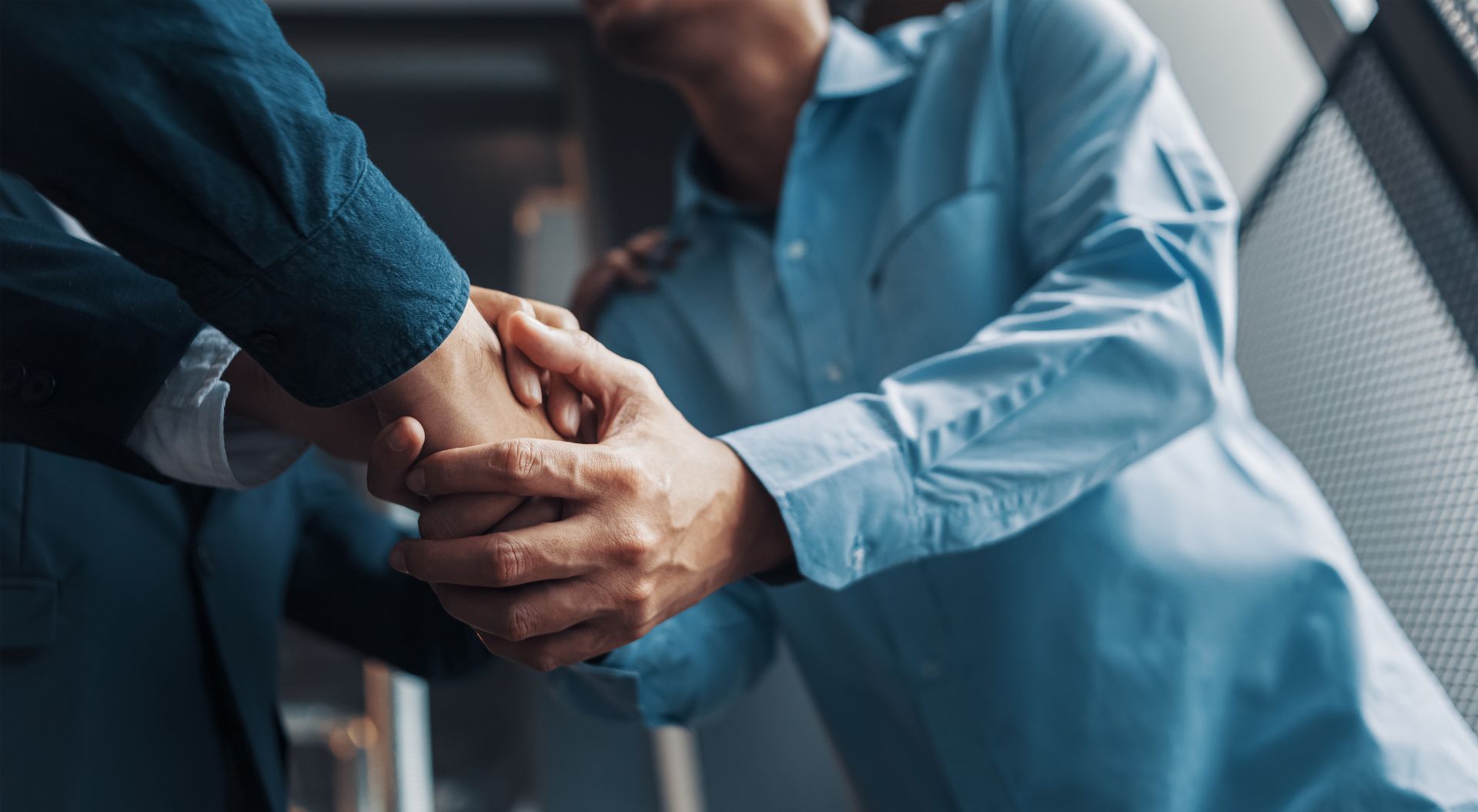 Successful businessmen handshaking after good deal.