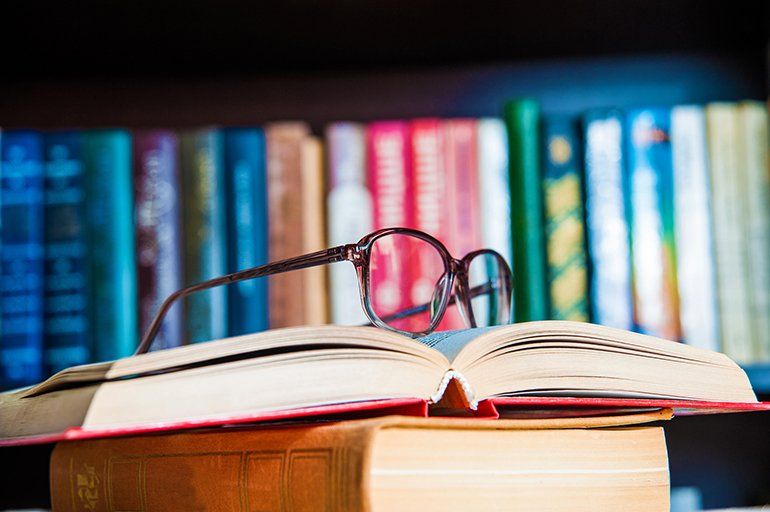 Elder Law Attorney ─ Glasses And Book In Tarpon Springs, FL