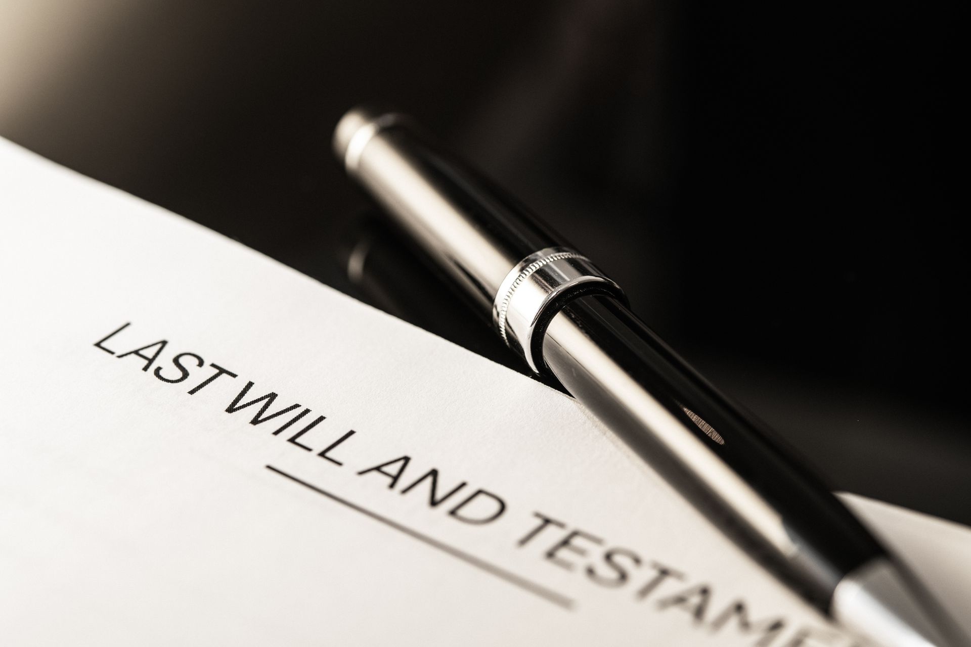 A close-up view of a last will and testament document with a sleek pen.