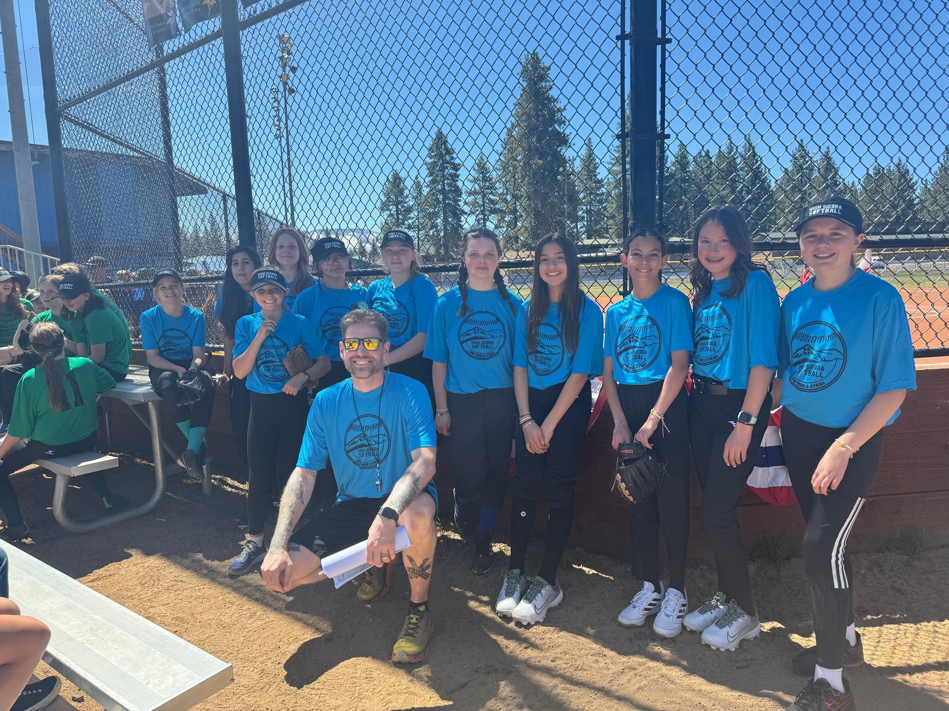 Baseball player sliding into home plate, catcher in front. Blue and gold uniforms, action shot.
