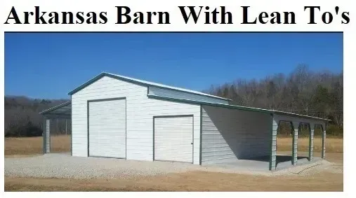 White barn with two garage doors and lean-to side sheds in a rural field under a blue sky