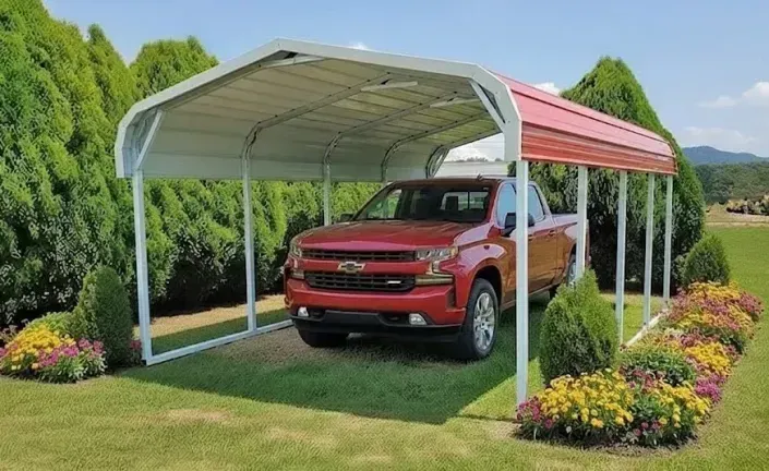 Red pickup truck parked under a white and red carport in a landscaped yard