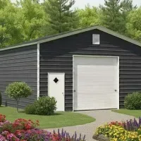 Dark gray garage with white roll-up door, side entry, and landscaped garden in front