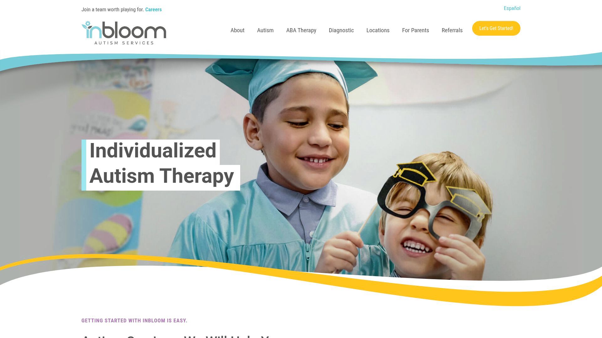 Two smiling children, one in a graduation cap, the other with toy glasses;