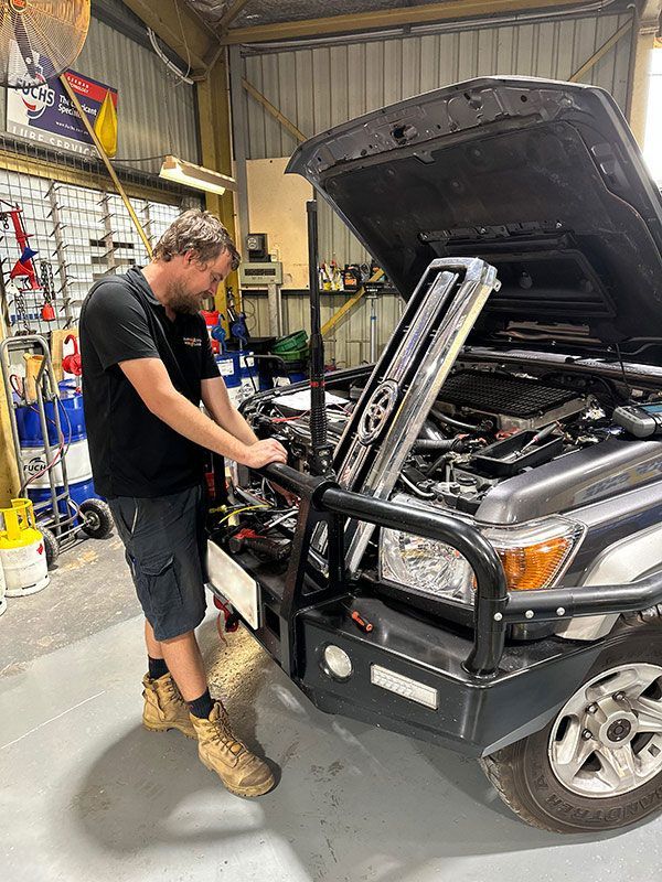 Man is Working on the Engine of a Car in a Garage — Darwin Auto Mobile Care in Woolner, NT