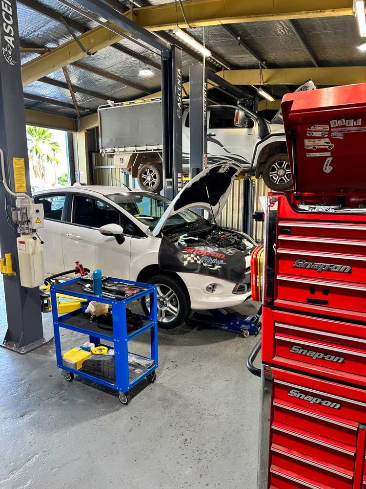 Car is Being Worked on in a Garage With the Hood Open — Darwin Auto Mobile Care in Woolner, NT