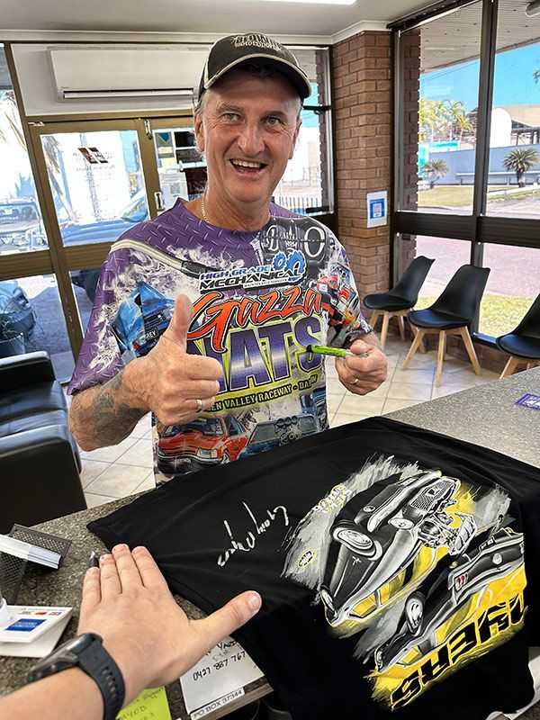 Man is Signing a T-shirt in a Store β Darwin Auto Mobile Care in Woolner, NT