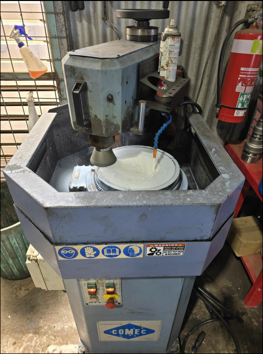 A surface grinder with a white grinding wheel and a metal basin - Darwin Auto Mobile Care in Woolner, NT