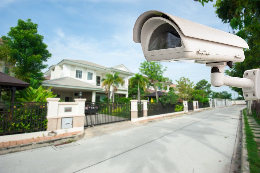 CCTV Camera With House In Background — Security System Installations In Ballina, NSW