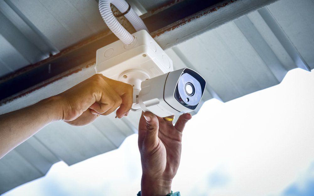 Technician Installing CCTV Camera Security System — Security System Installations In Casino, NSW