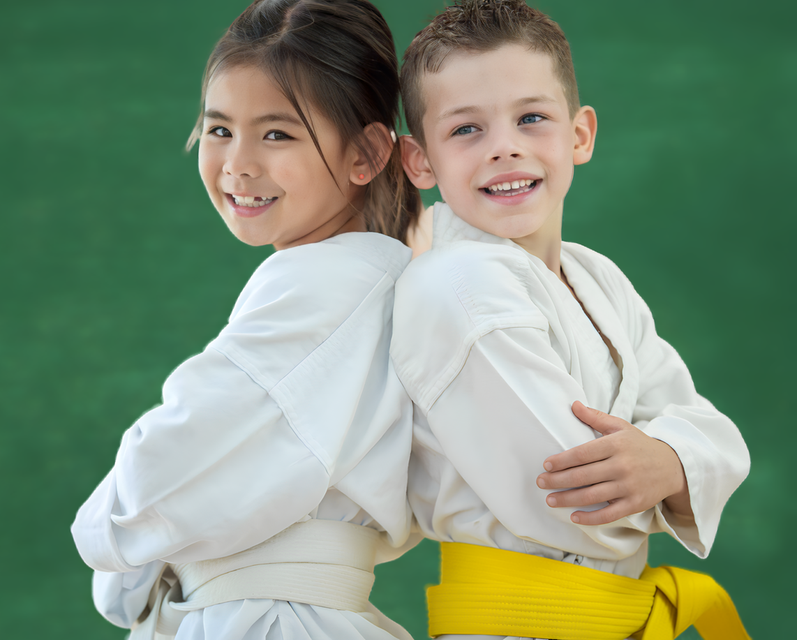 A boy and a girl are standing back to back and smiling