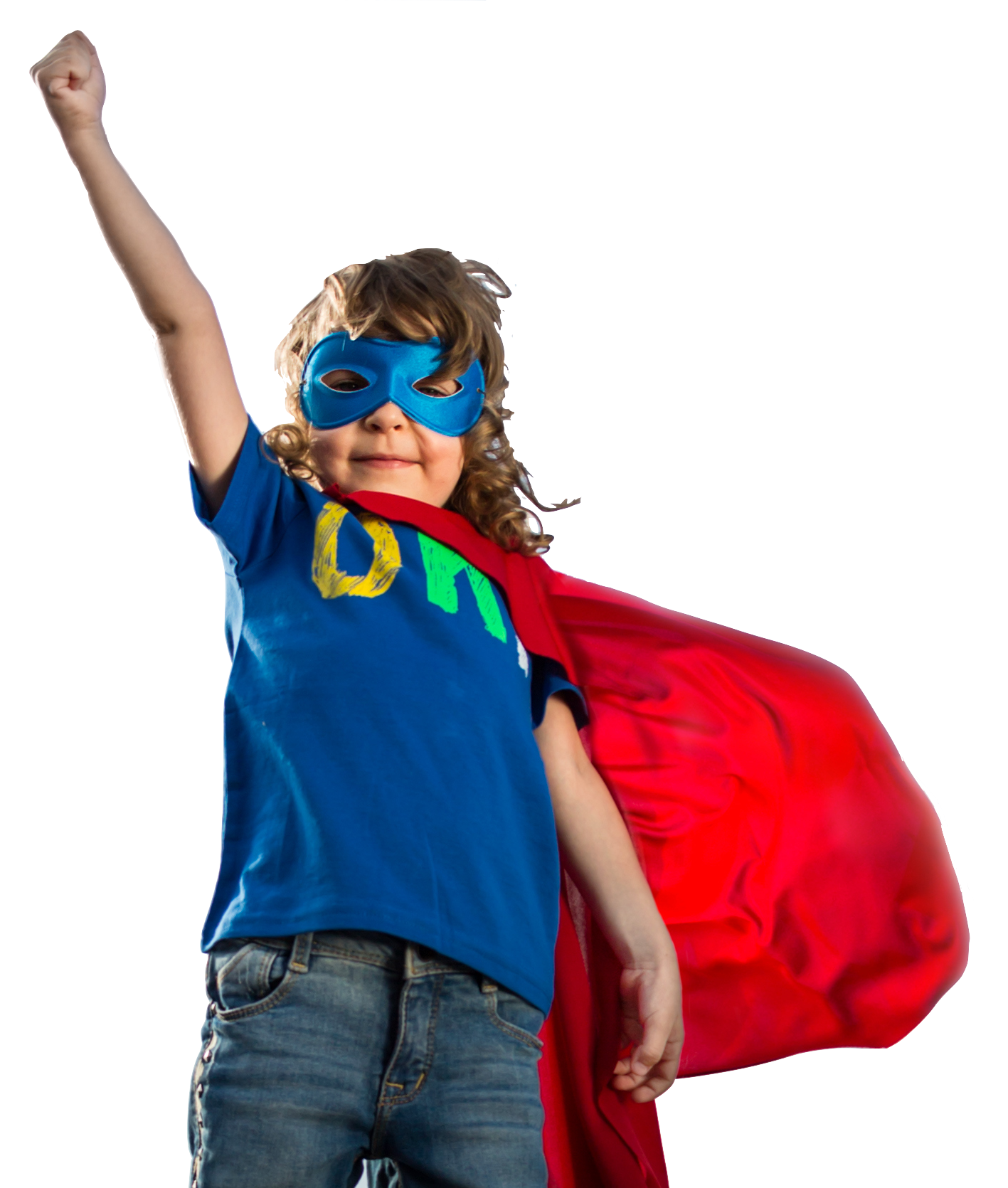 A young boy wearing a superhero cape and mask is raising his fist in the air.