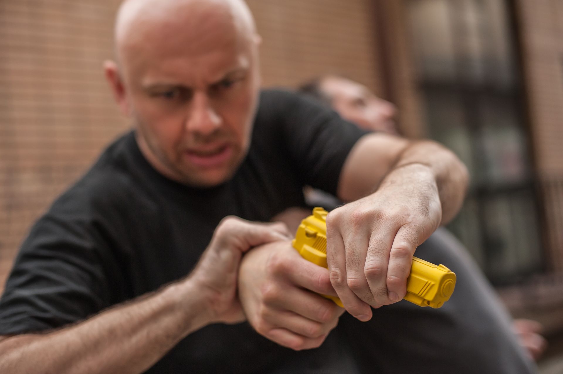 A man is holding another man 's hand while holding a yellow object.