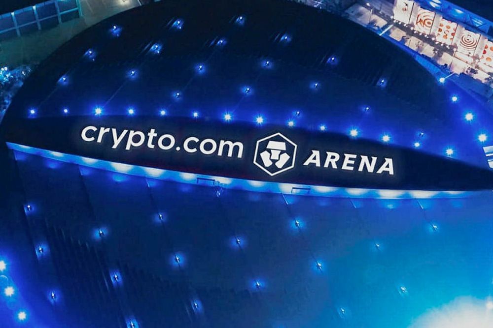 Crypto.com Arena sign lit up at night, with blue lights and a logo.