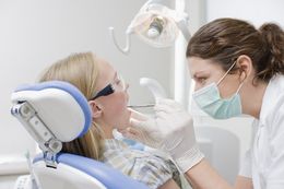 A dentist going through general dentistry advice with a young boy in Busselton