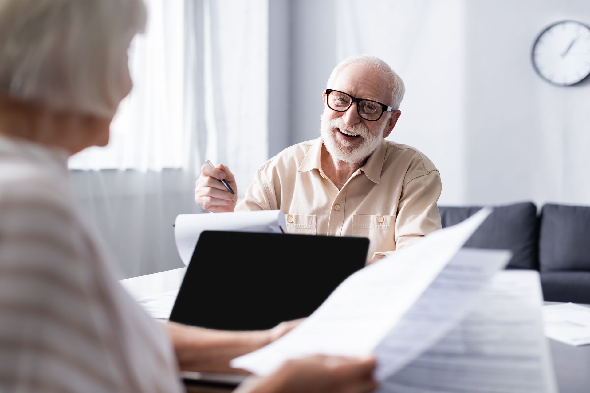 Senior man reviewing power of attorney documents with spouse during estate planning consultation
