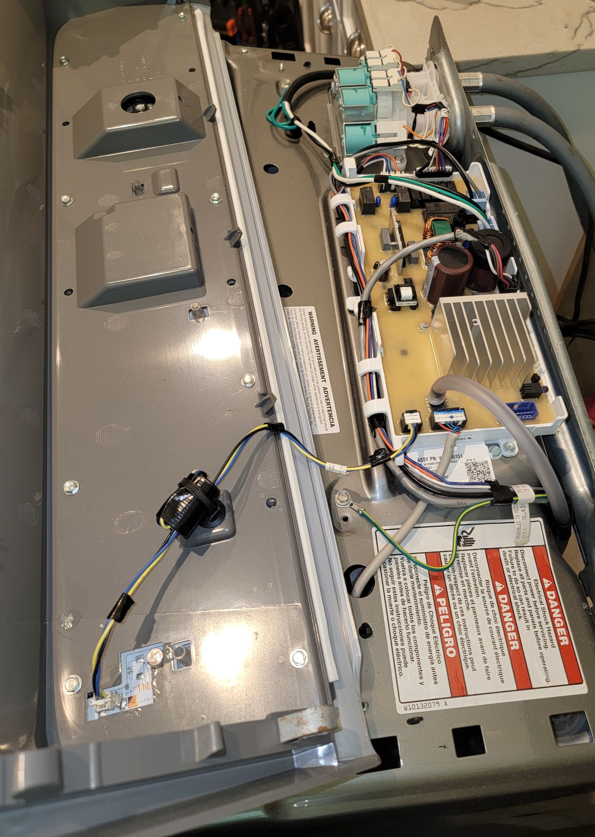 The inside of a washing machine with a warning label on it.