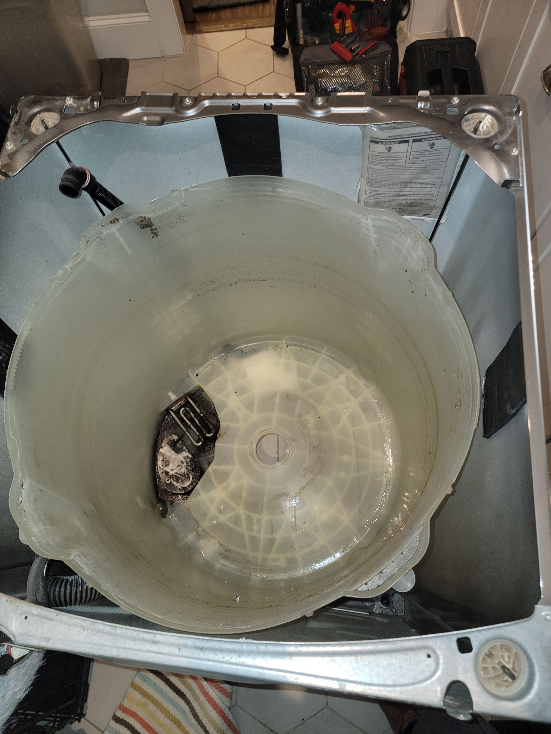 The inside of a washing machine is filled with water.