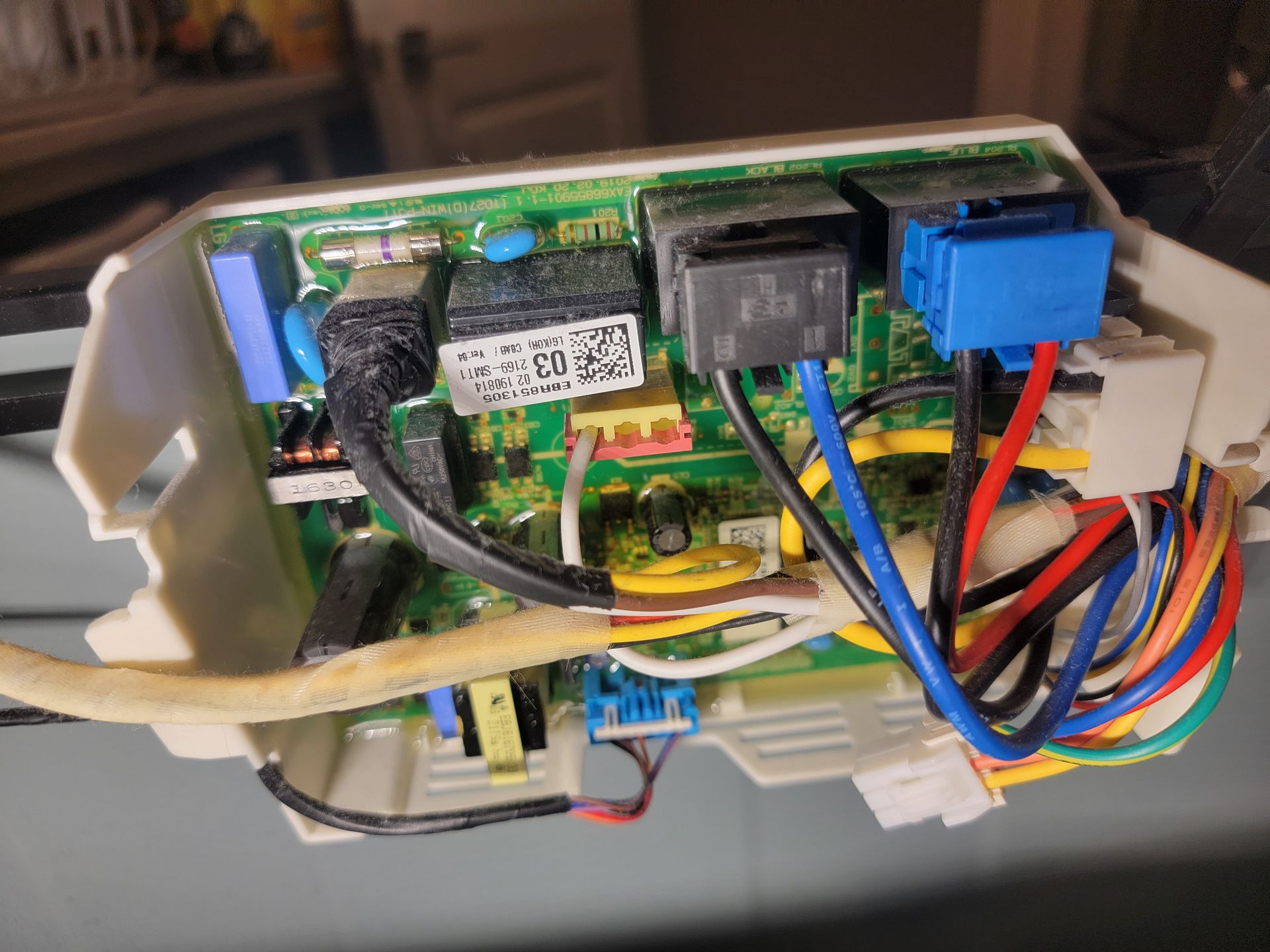 A close up of a motherboard with a lot of wires coming out of it.