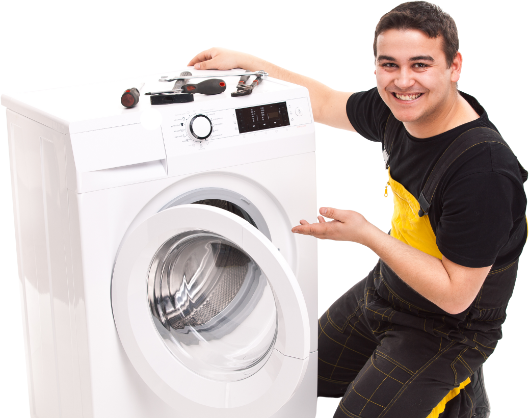 A man is working on a washing machine and smiling