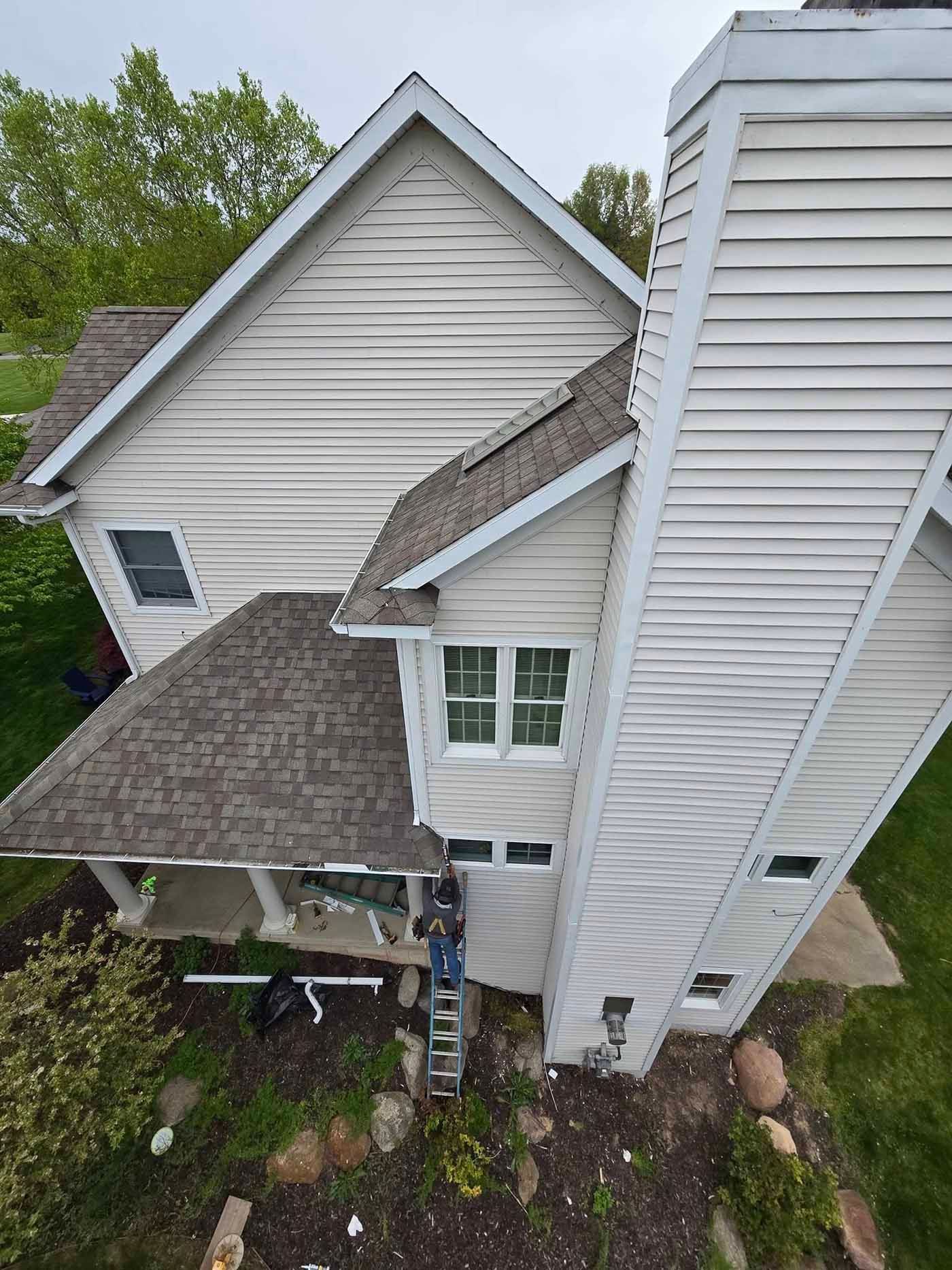 An aerial view of a house with a ladder on the side of it.
