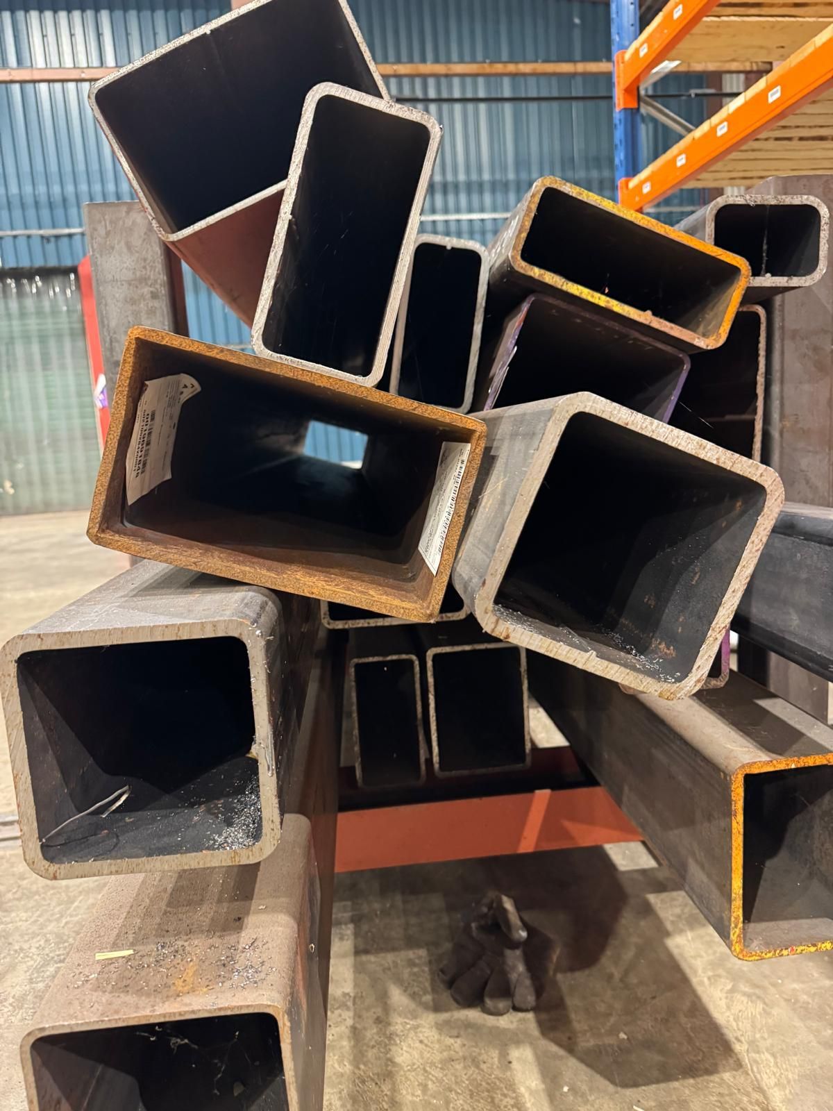 An assortment of steel box section ends stacked