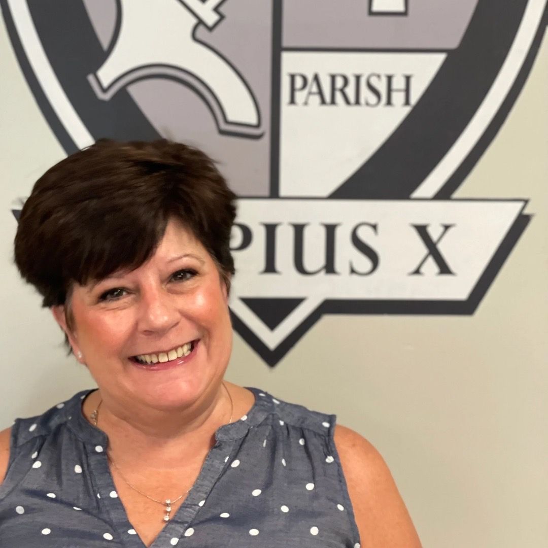 A woman is smiling in front of a parish logo