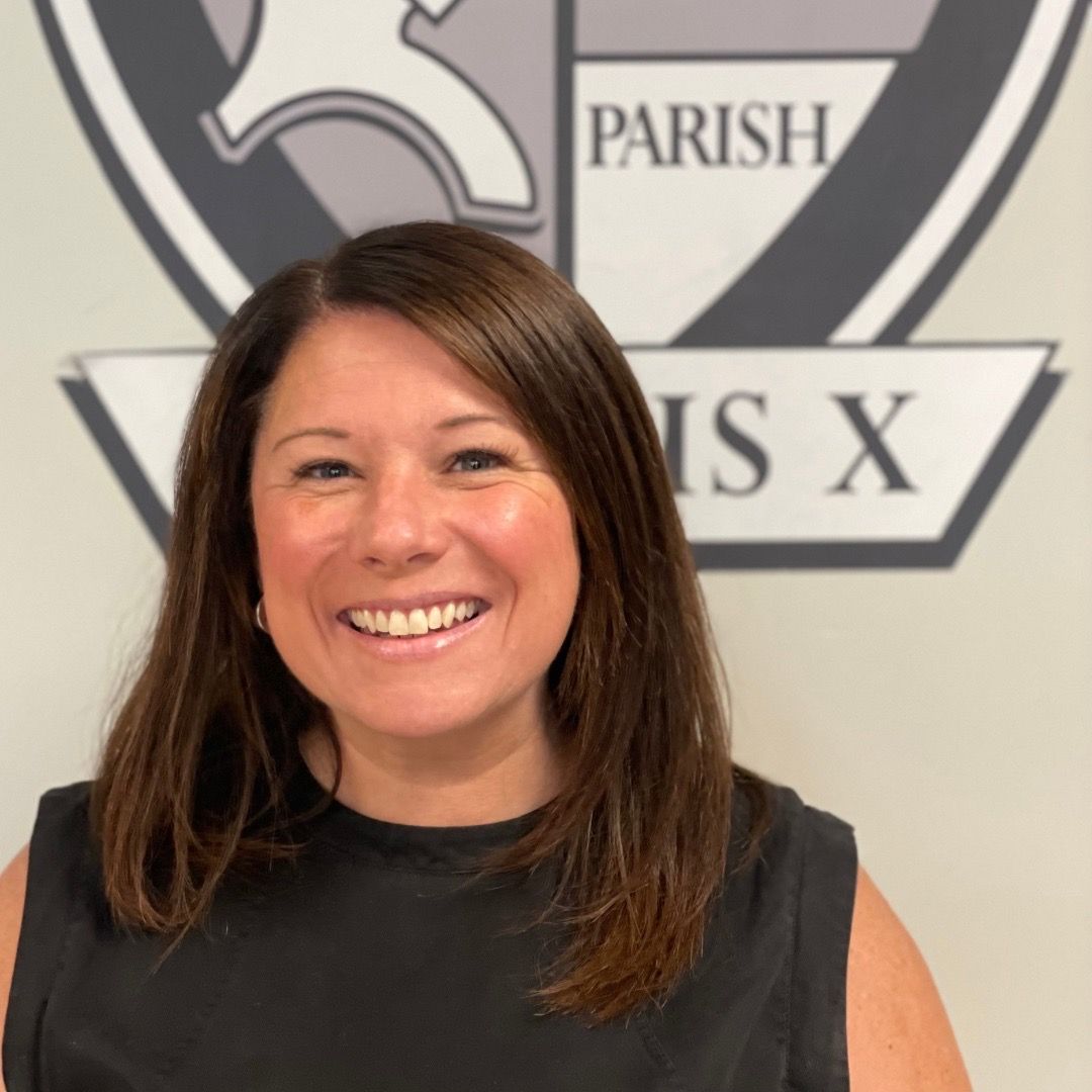 A woman is smiling in front of a parish logo.