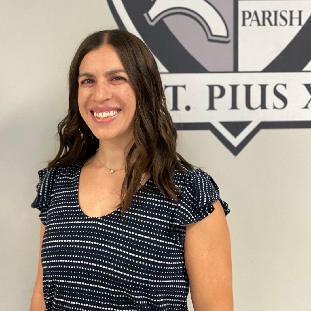 A woman is smiling in front of a parish logo