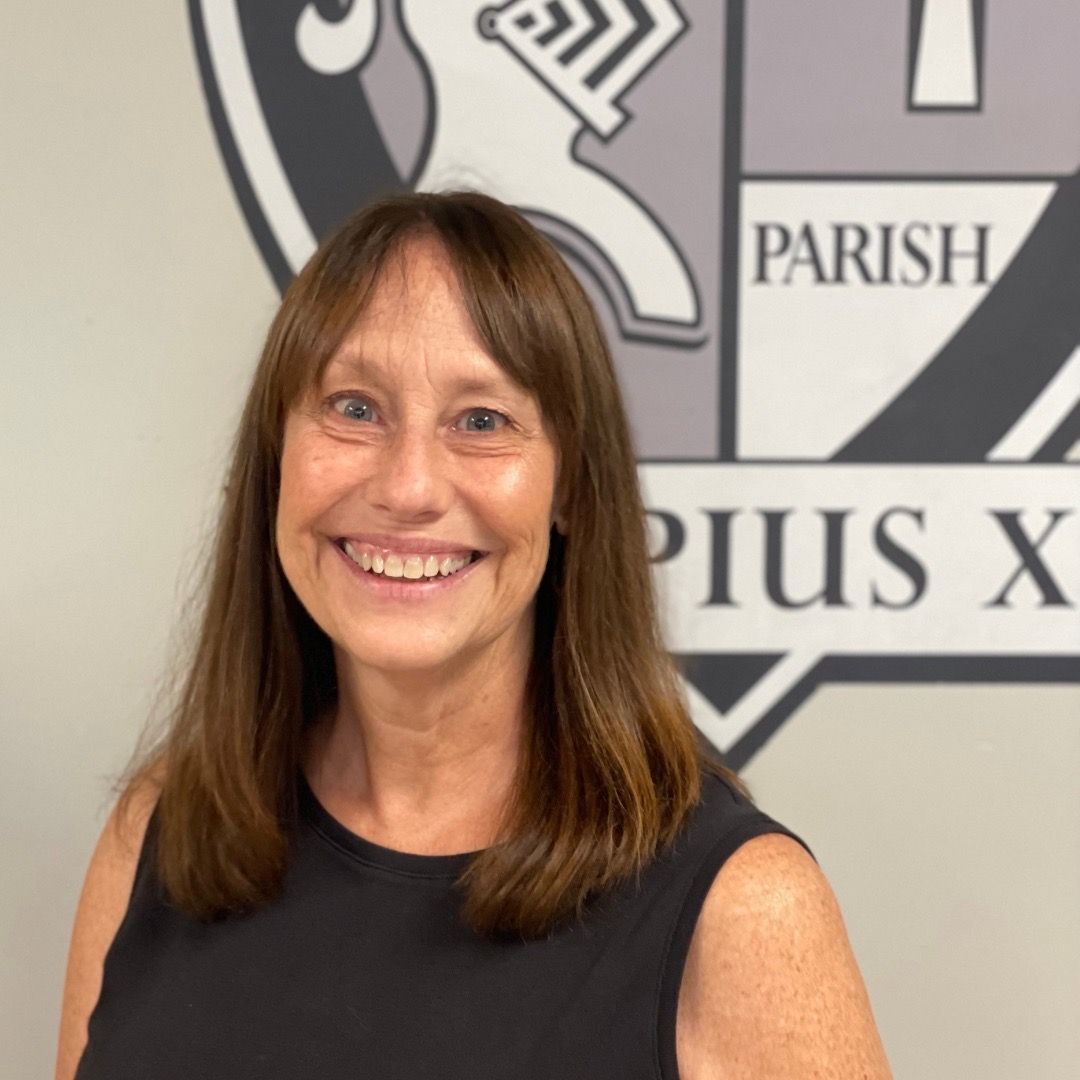 A woman is smiling in front of a parish logo