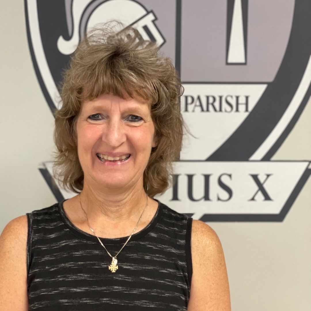 A woman is smiling in front of a parish logo