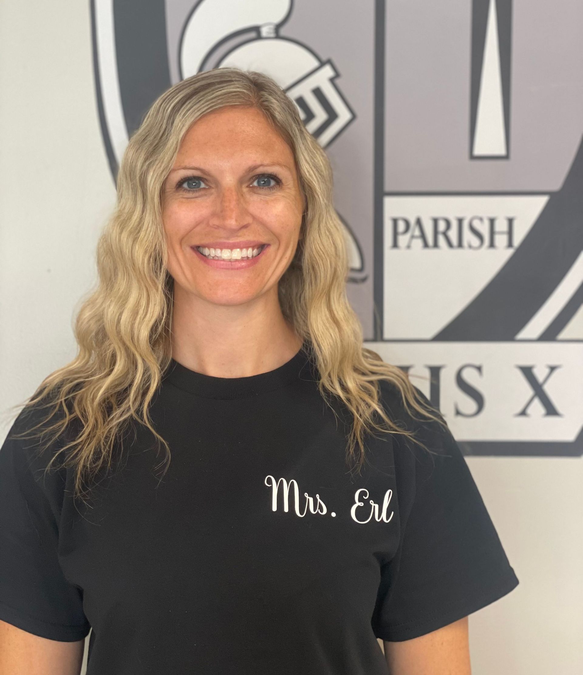 A woman wearing a black shirt that says mrs. eve