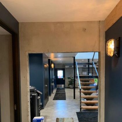 A hallway with stairs leading up to the second floor of a house.