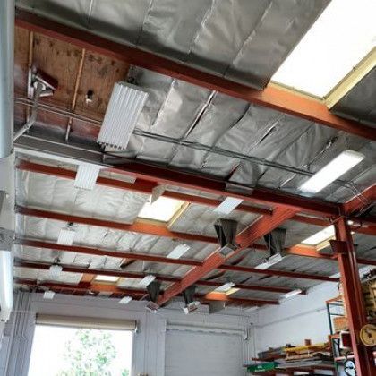 The ceiling of a garage with a lot of lights on it.