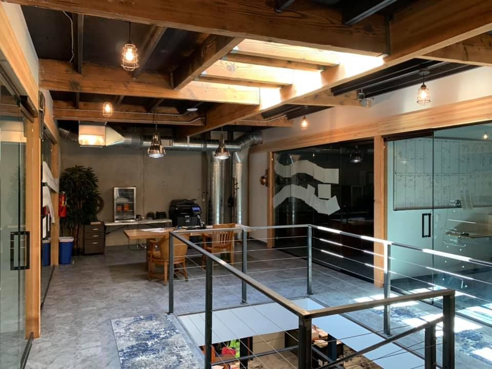 A large room with a wooden ceiling and a glass wall.