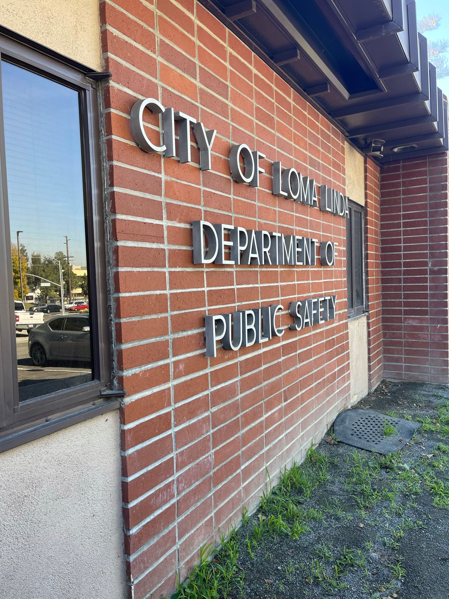 A brick building with a sign that says city of long beach department of public safety