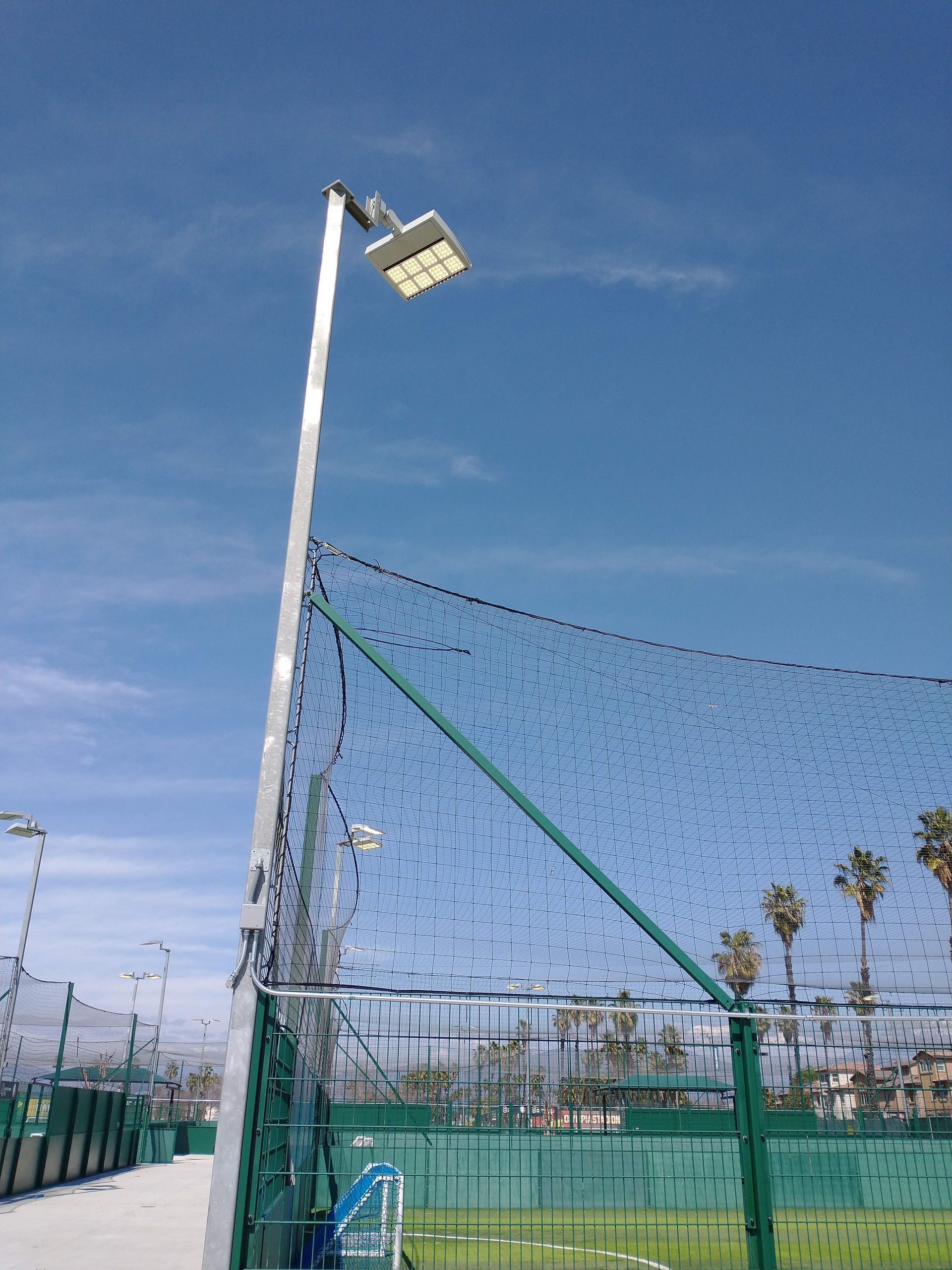 A tennis court with a light on top of it