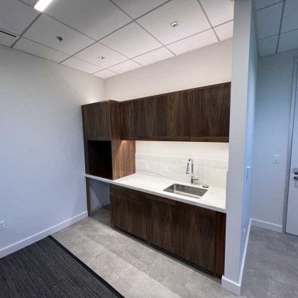 A kitchen with wooden cabinets and a sink.