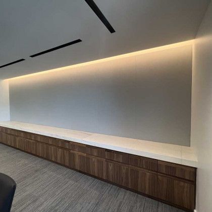 There is a large wall with a lot of drawers underneath it.